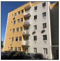 Apartamento em prédio de fachada mista bege e amarela com varandas e 1 vaga de garagem em área externa