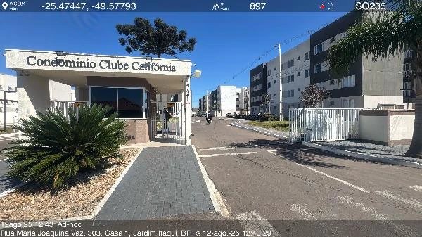 Apartamento com fachada branca e portaria do Condomínio Clube California em área urbana com calçada acessível