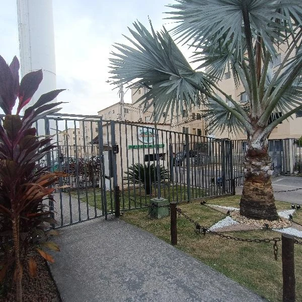 Apartamento com portão de entrada, palmeiras e área externa no condomínio