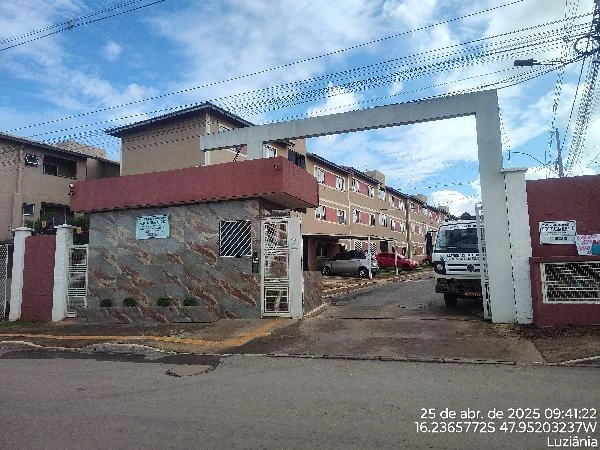 Apartamento com fachada em condomínio residencial, portaria e entrada principal com guarita e veículos no interior